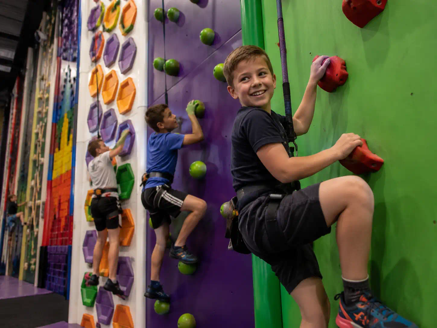 Children taking on colourful Clip ’n Climb challenges at a birthday party