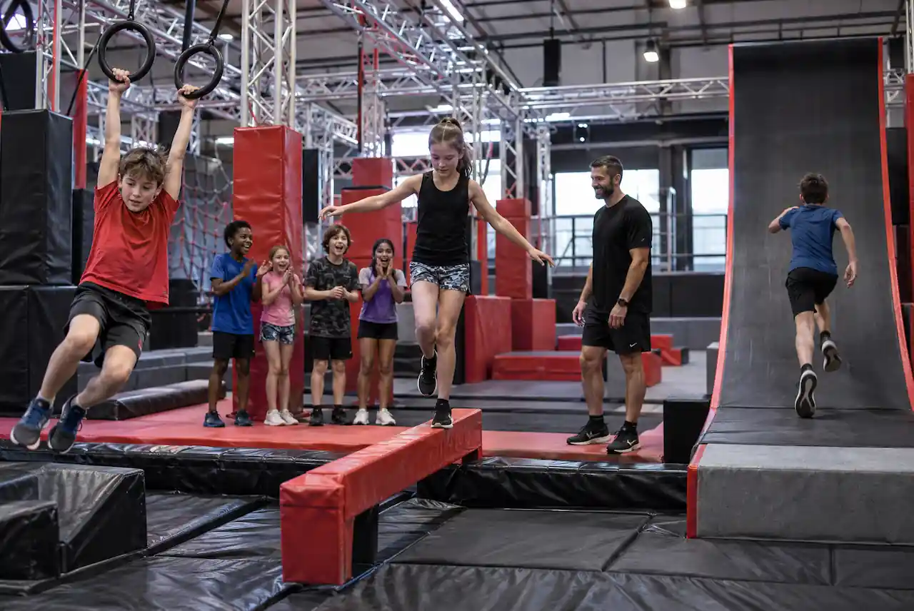 Children tackling a Ninja Warrior style obstacle course at a birthday party